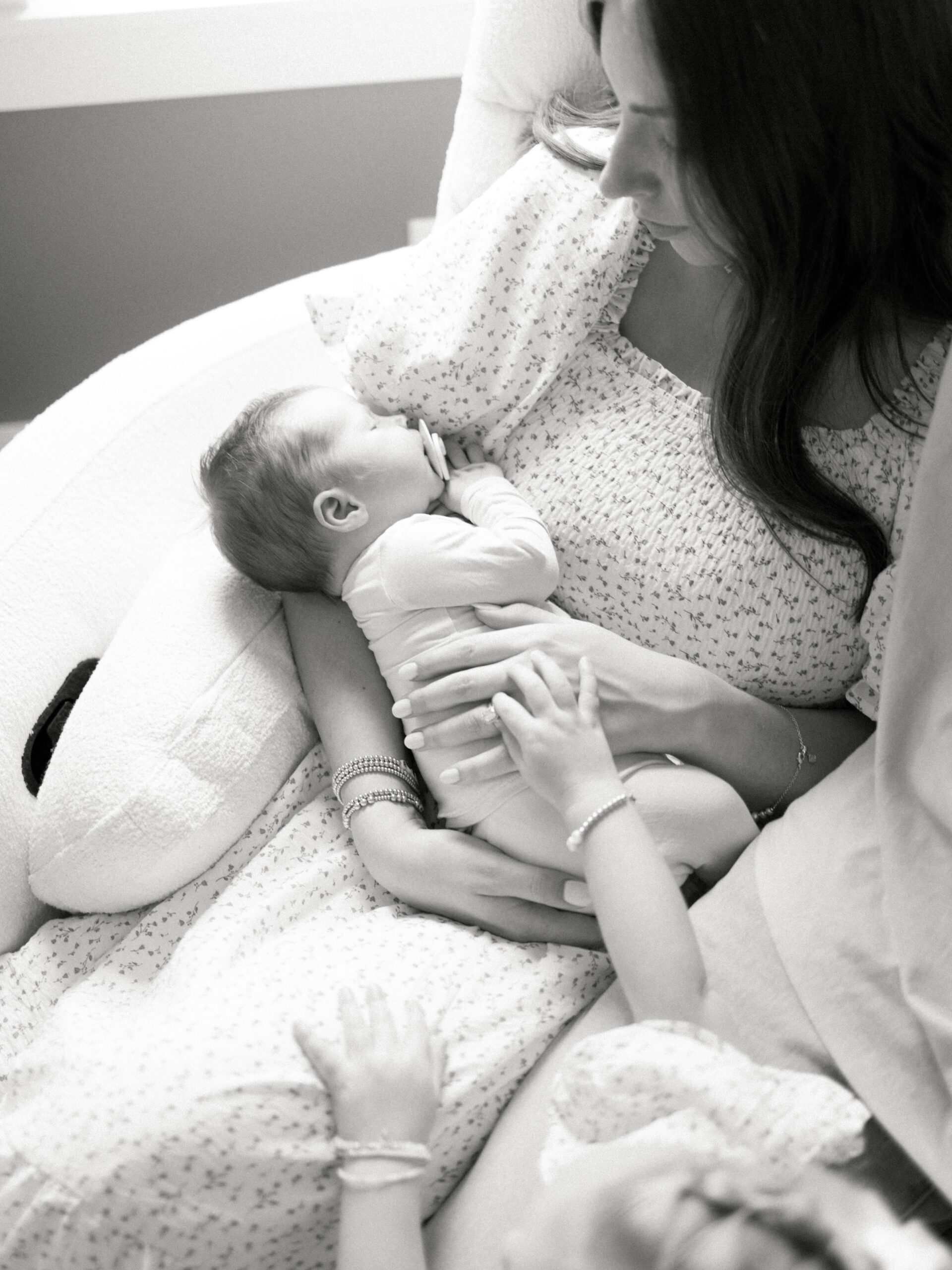 Postpartum mom with her son sitting in a rocking chair taken by College Station Newborn Photographer, Meg Staheli Photo