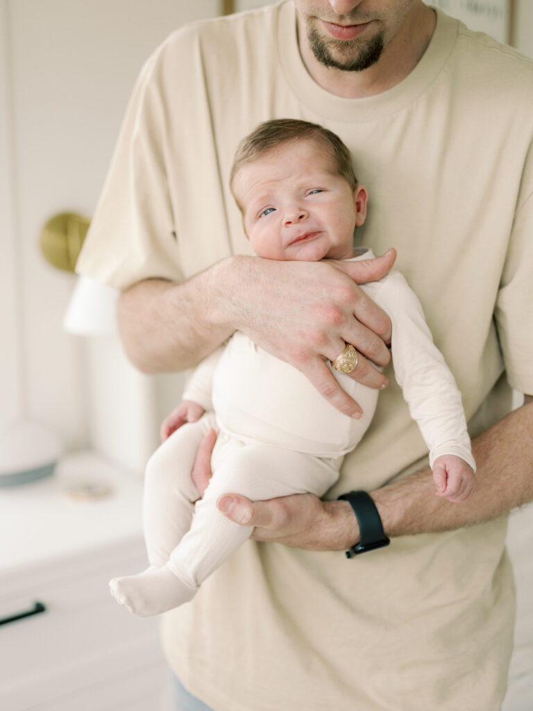 Photo of dad and baby taken by College Station Newborn Photographer, Meg Staheli Photo.