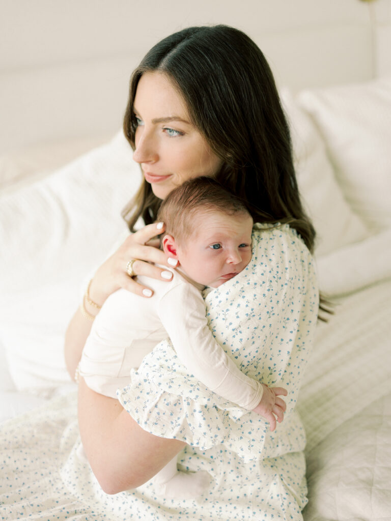 Photo of mom and baby snuggling taken by College Station newborn photographer Meg Staheli Photo