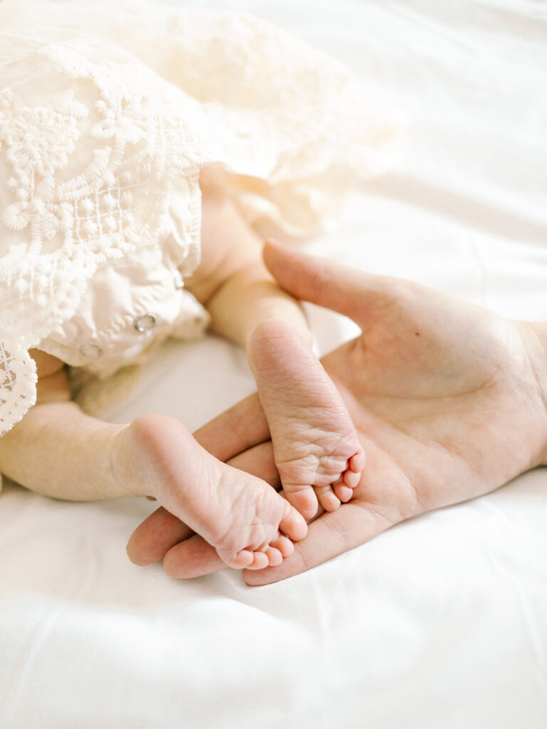 College Station Newborn Photographer takes newborn photos of baby girl's feet.